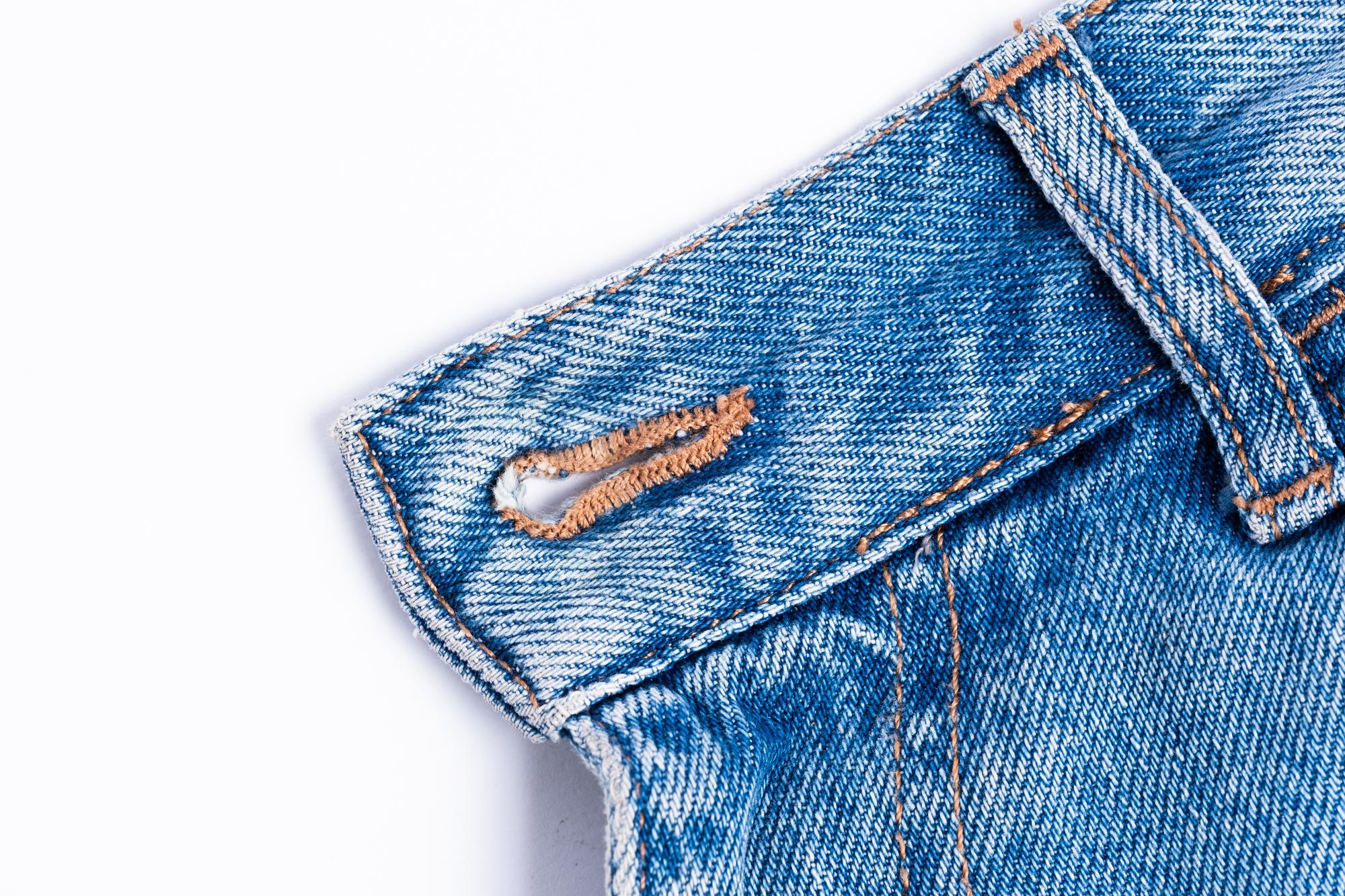 Close-up colorful stitchwork on denim jacket