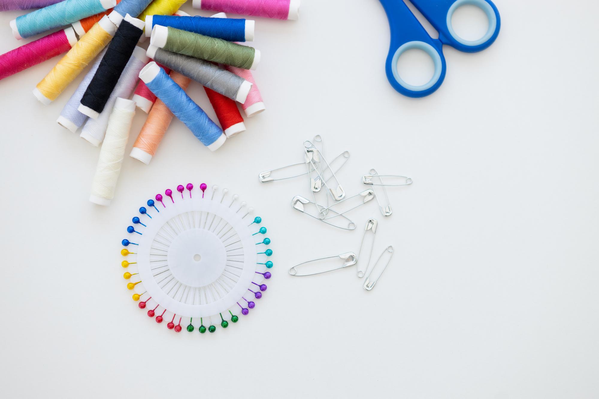 Flatlay of embroidery tools and color cards